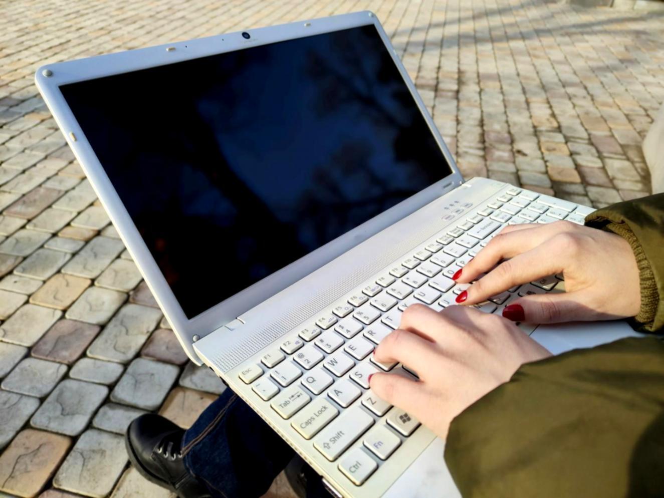 Person reviewing financial documents with calculator and coffee